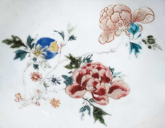 圖為清中期粉彩花卉紋剃須盤細(xì)節(jié)圖，盤心主題紋飾為花卉圖。（來源：廣州十三行博物館）
